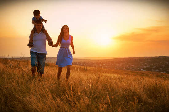 Family walking in field